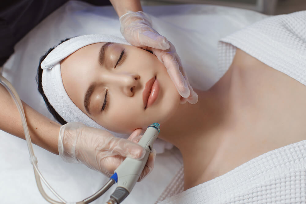 Woman under the microdermabrasion process