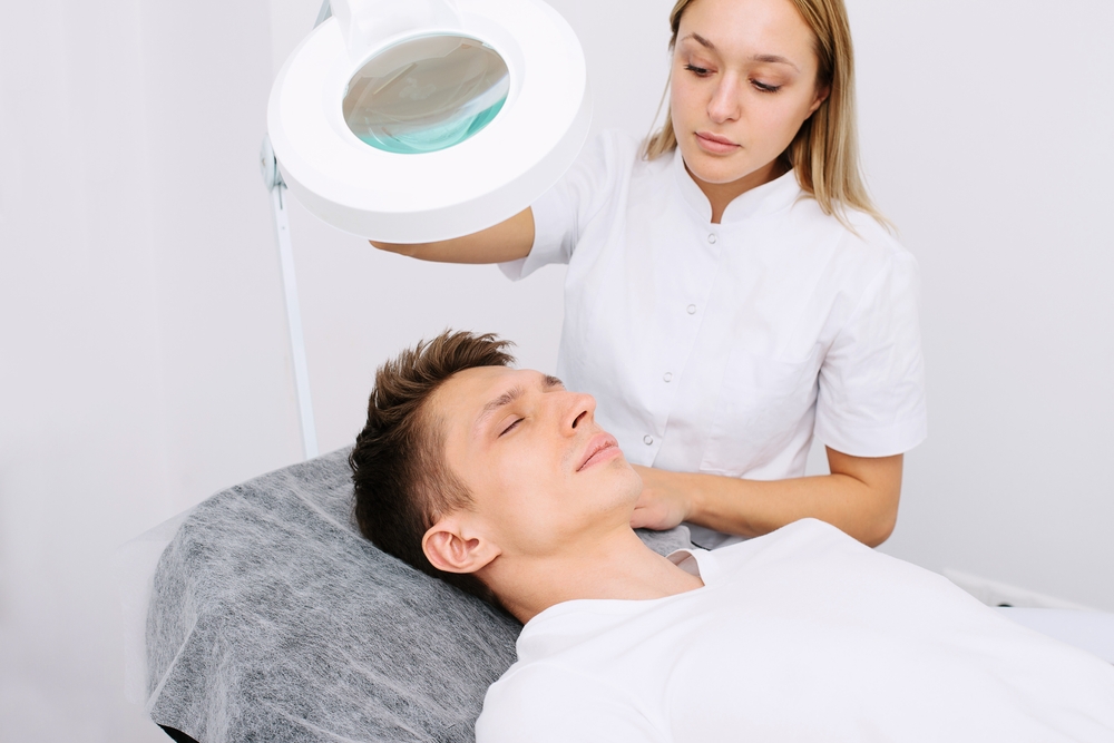 Men patient under a consultation with dermatologist