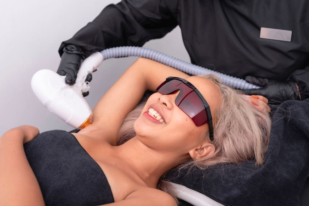 Woman’s patient under hair removal treatment